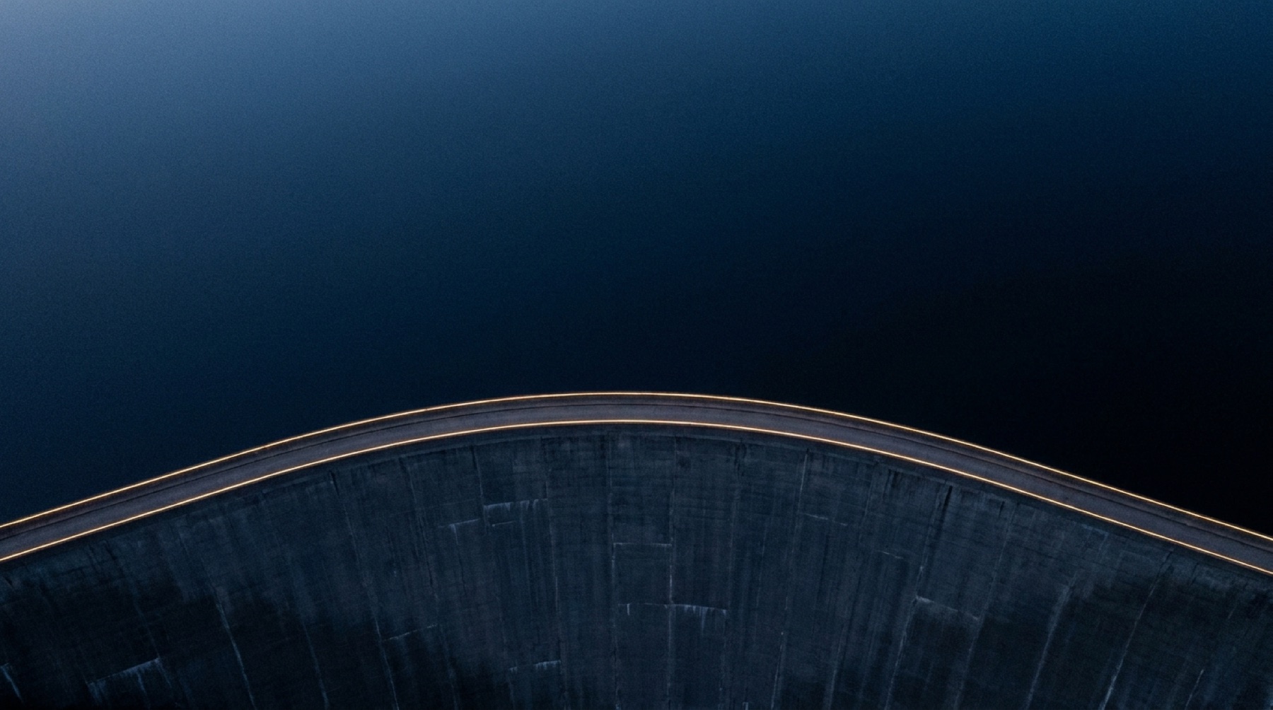 Aerial view of a concrete dam at blue hour